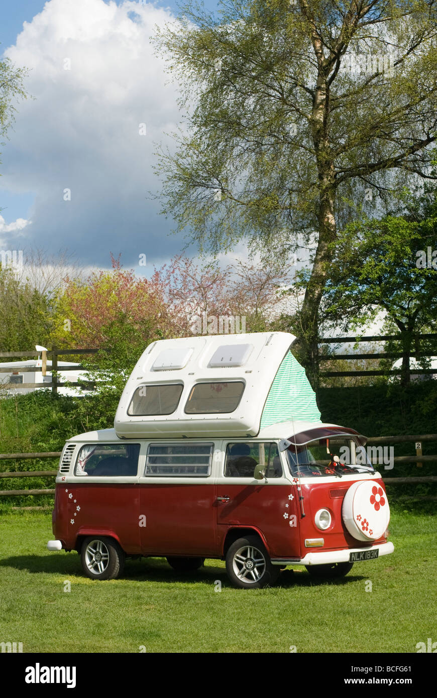 1972 Red volkswagen camper van with its roof extended on a campsite in Derbyshire on a sunny summers day Stock Photo