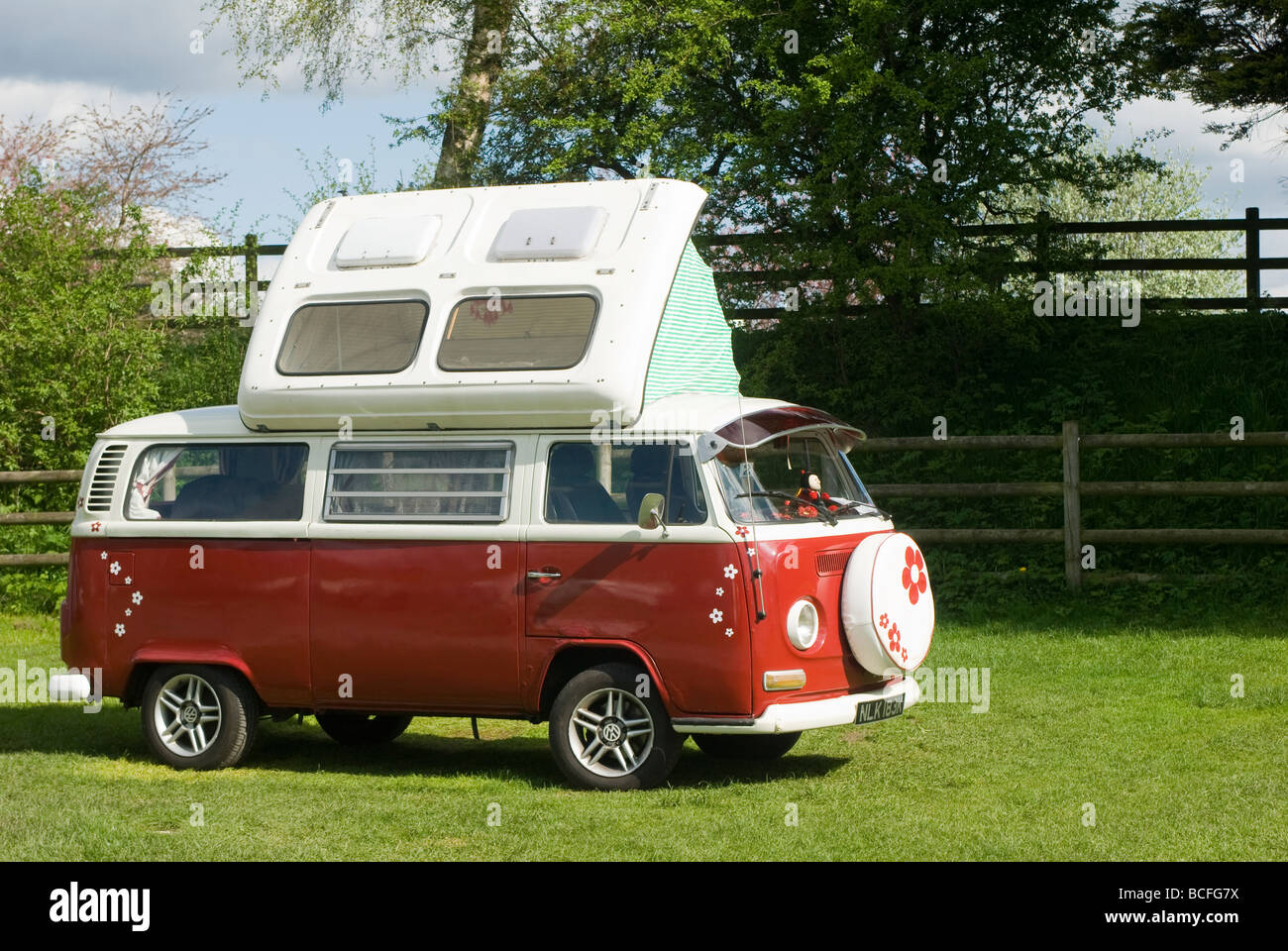 1972 Red volkswagen camper van with its roof extended on a campsite in Derbyshire on a sunny summers day Stock Photo