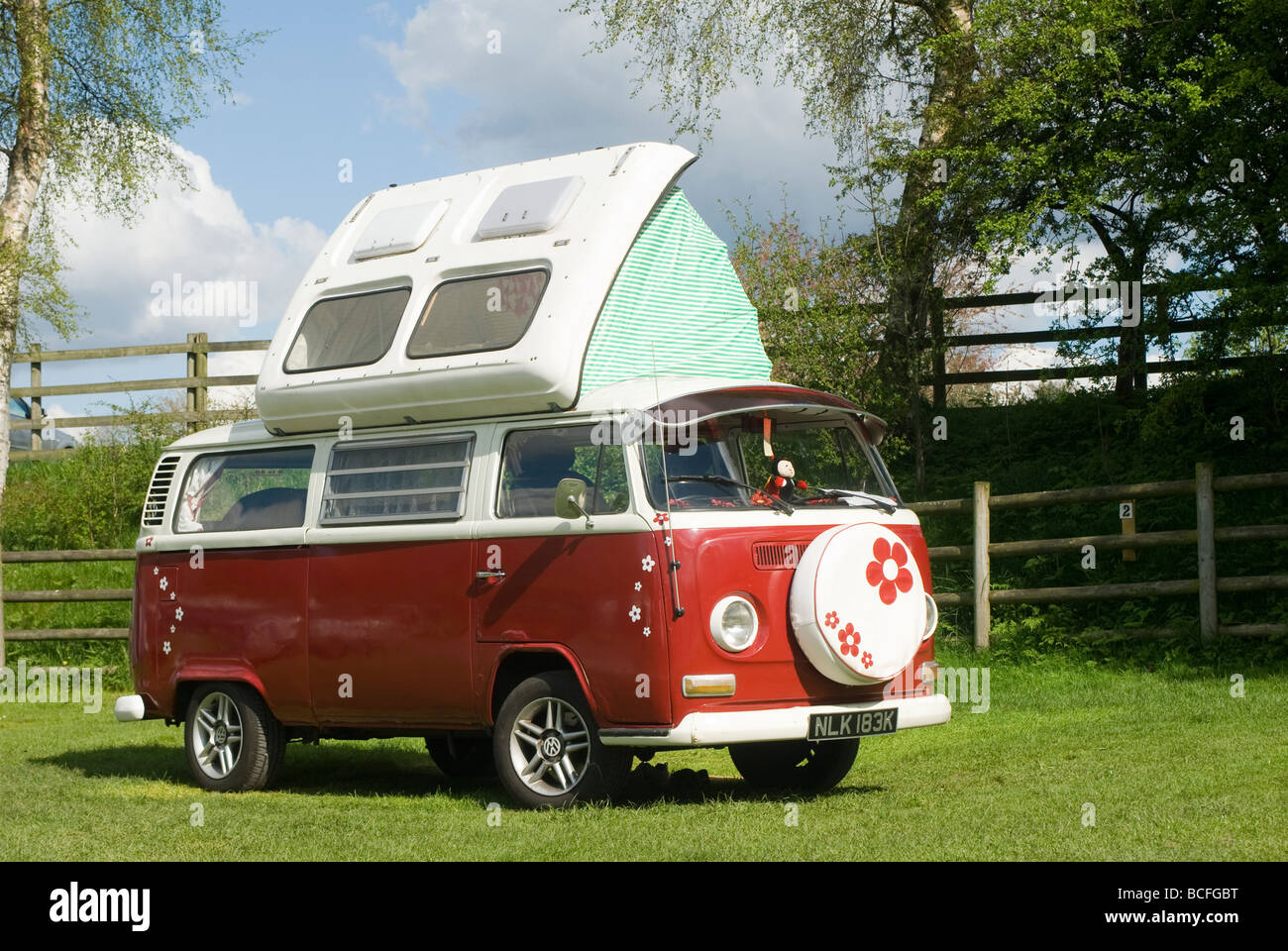 1972 Red volkswagen camper van with its roof extended on a campsite in Derbyshire on a sunny summers day Stock Photo