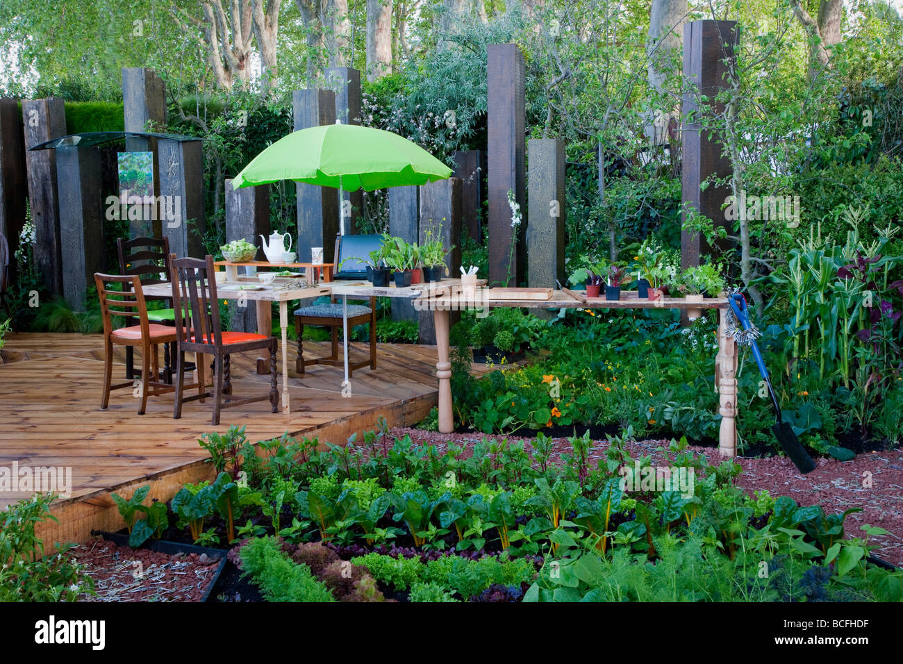 Table And Chairs On Deck With Green Umbrella With Adjacent Work