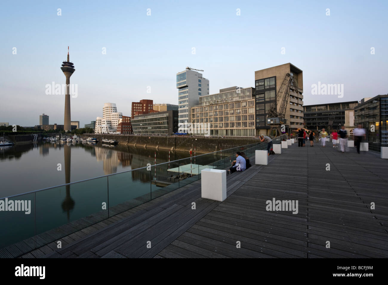 view from footbridge across Dusseldorf mediaharbor to Rhine tower and marina Stock Photo