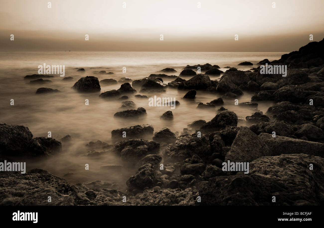Black rocks in the sea hi-res stock photography and images - Alamy