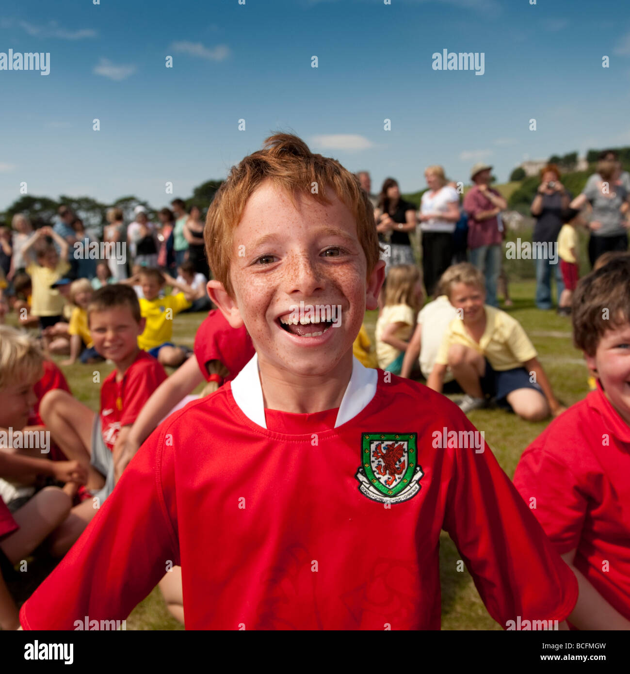 a happy laughing red haired freckled faced boy during Primary School sports day UK Stock Photo