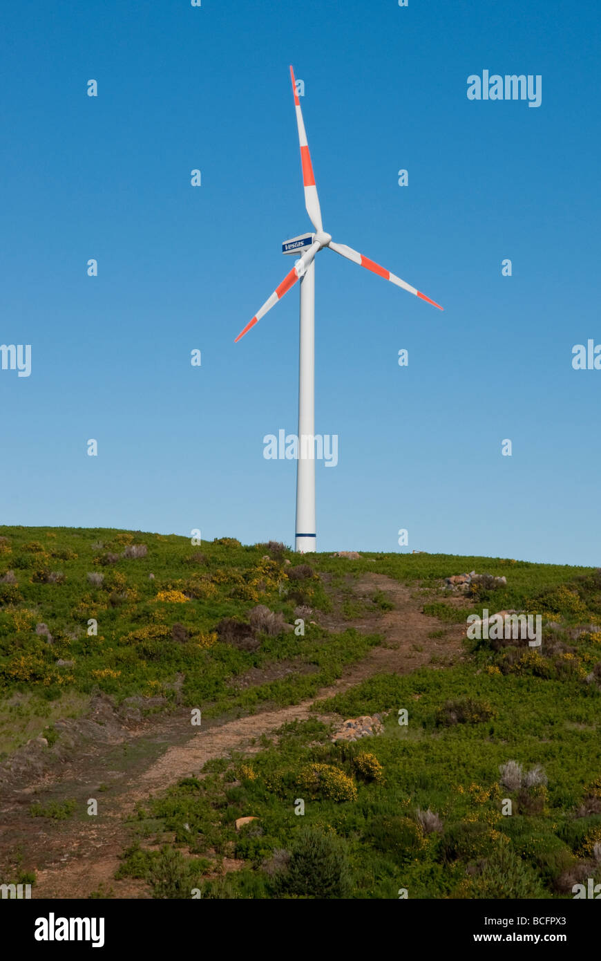 Wind turbine on hill, with blue sky Stock Photo - Alamy