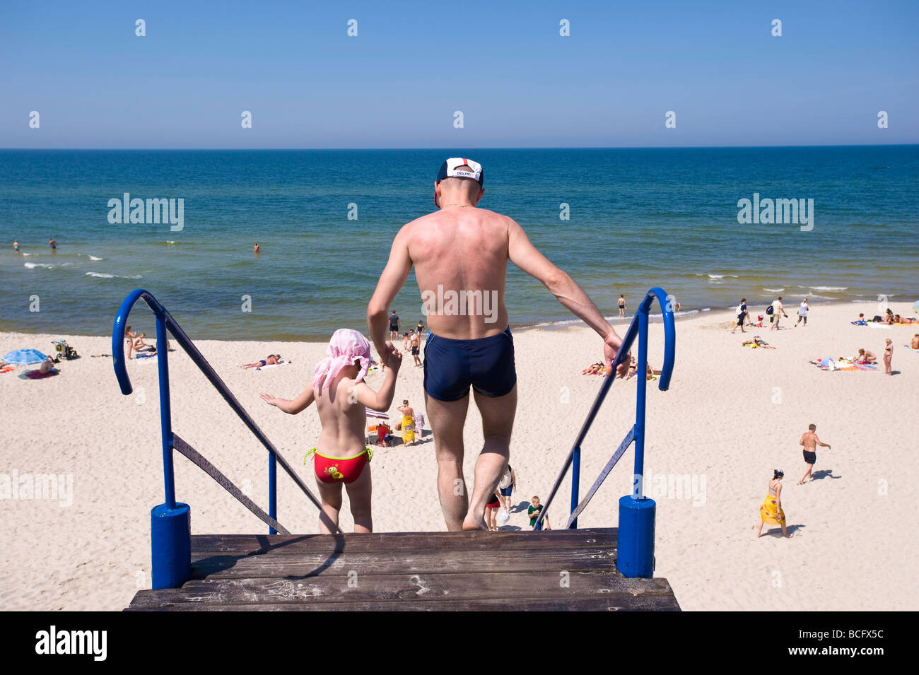 People enjoy hot summer day on sandy beach Baltic Sea Nida village Neringa Lithuania Stock Photo