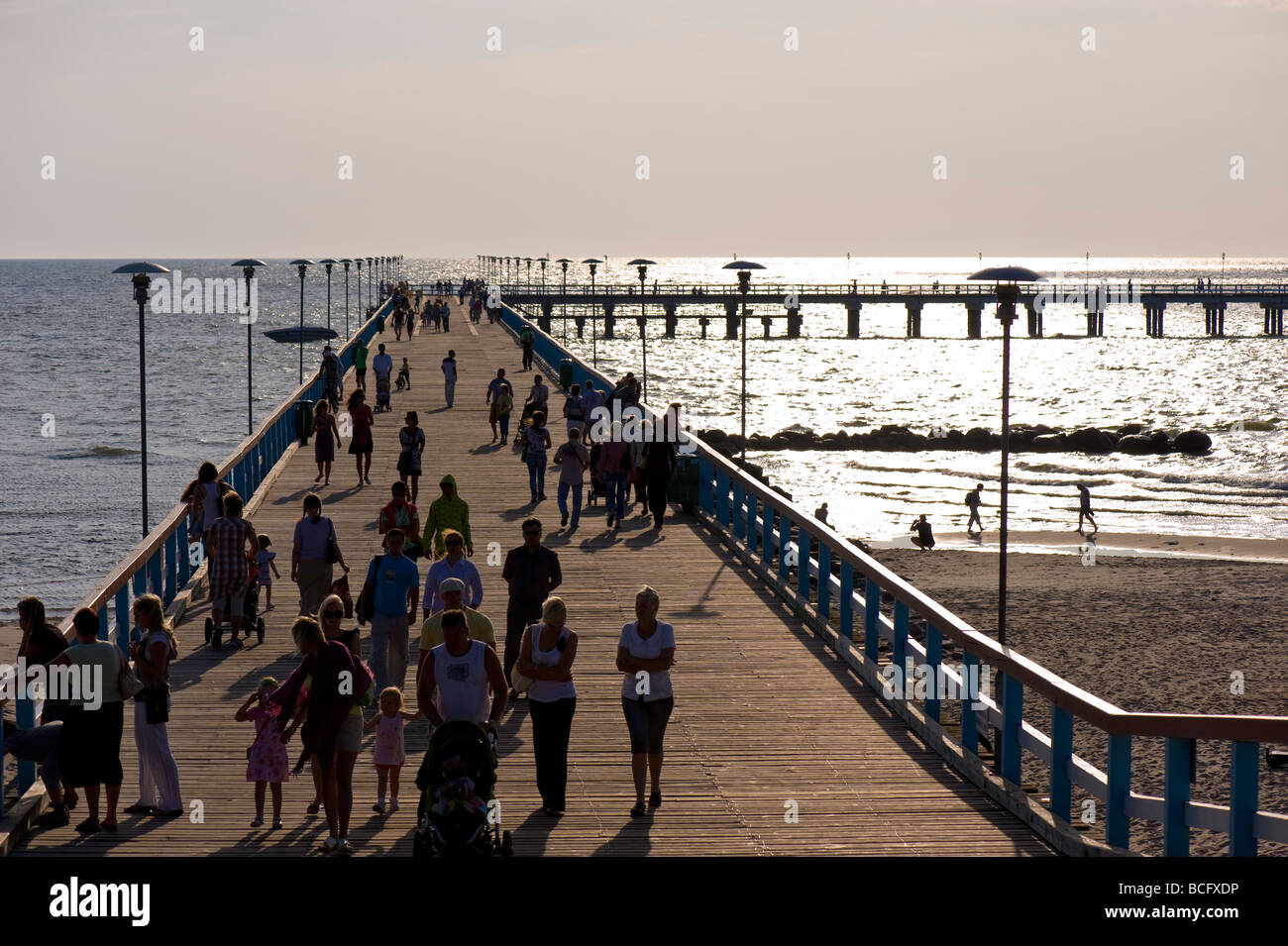 People stroll on a pier on a warm summer afternoon Palanga Lithuania Stock Photo