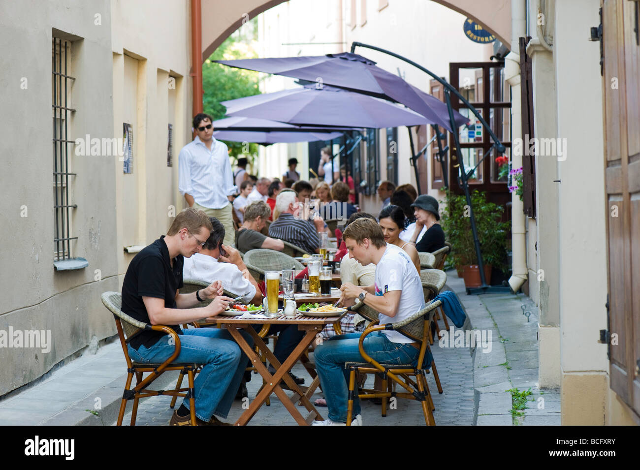 Restaurant on sidewalk busy with diners Old Town Vilnius Lithuania Stock Photo