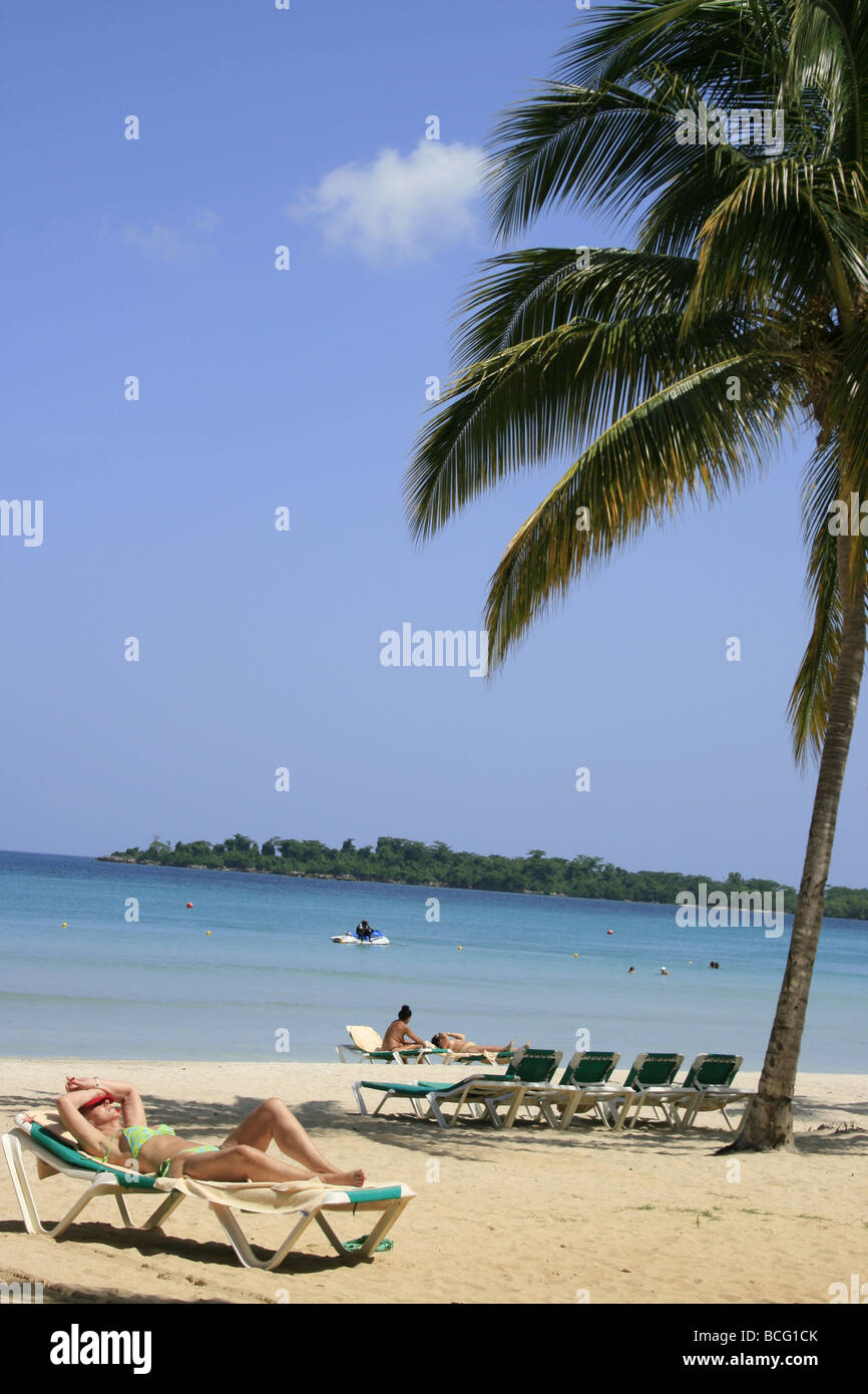 Tourist sunbathing, Bloody Bay beach, Negril, Jamaica Stock Photo
