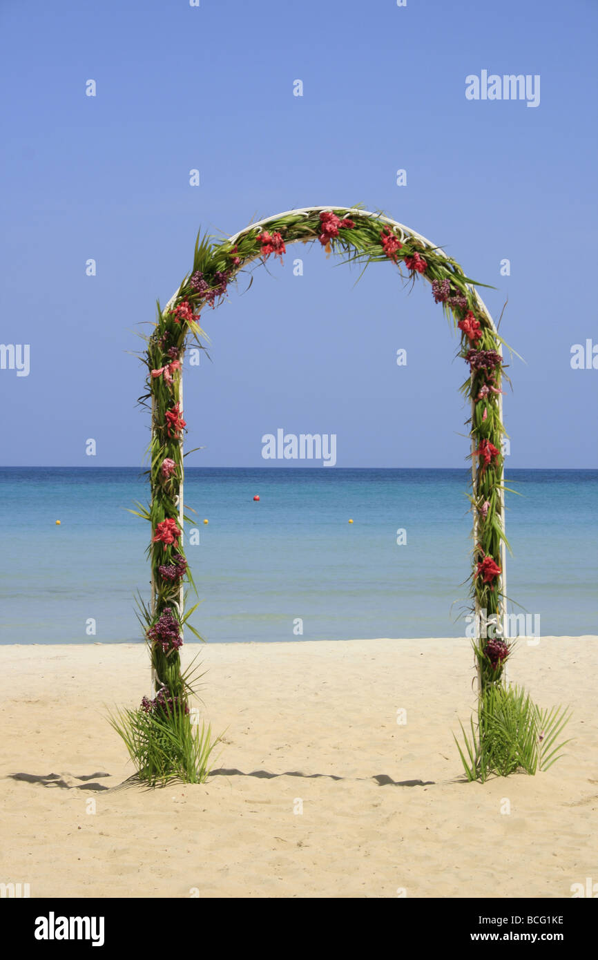 Arch decorated with tropical flowers on the  beach, Negril, Jamaica Stock Photo