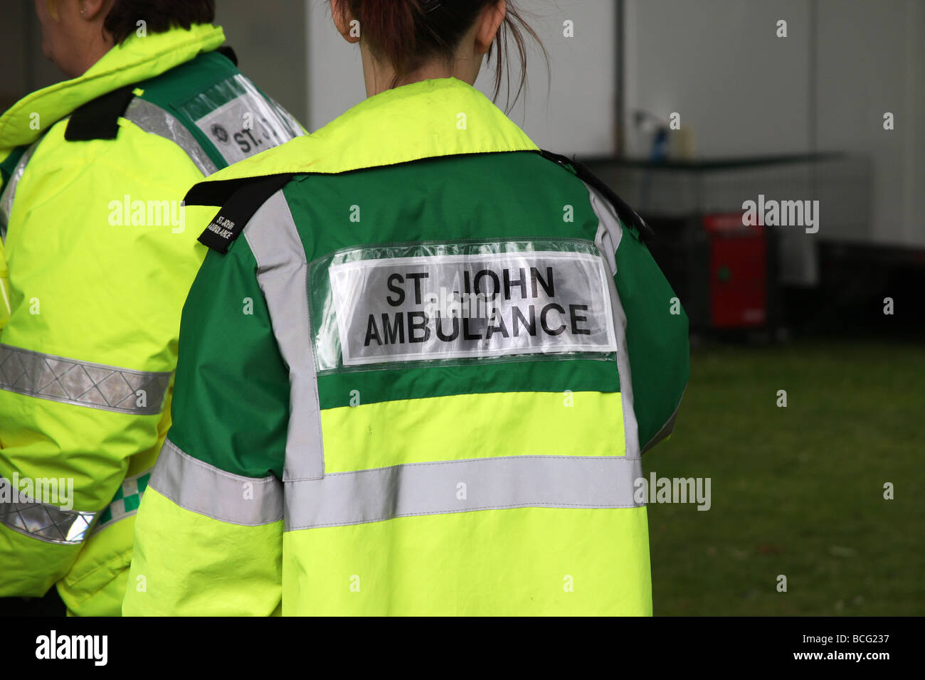 Saint Johns ambulance sign on back of flourescent jacket Stock Photo Alamy