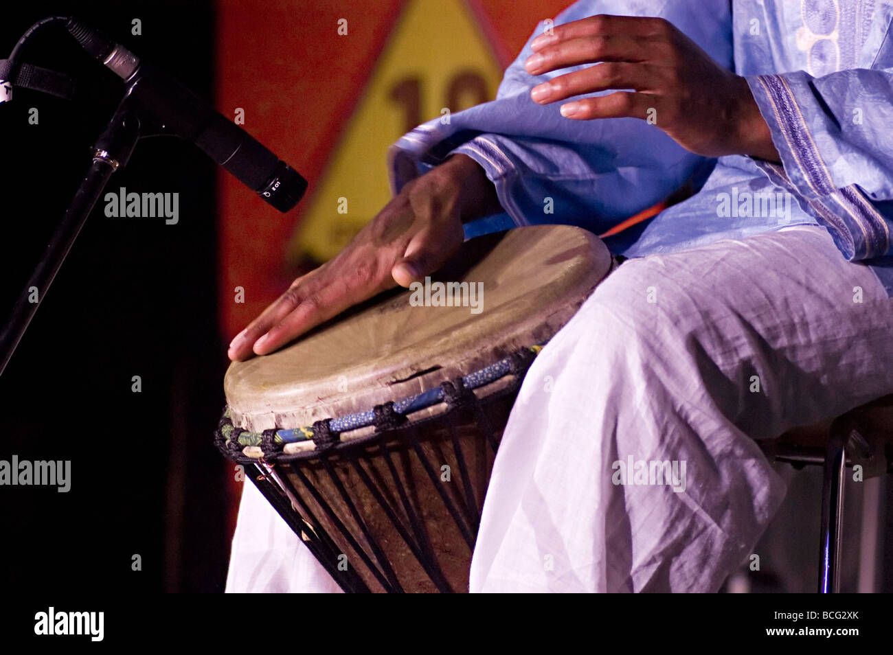 an African drum being hit during a live music performance in Birmingham