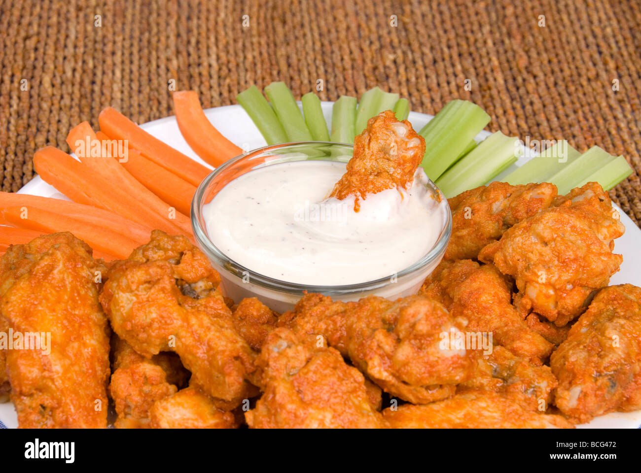 A spicy plate of chicken hot wings and dipping ranch sauce Stock Photo