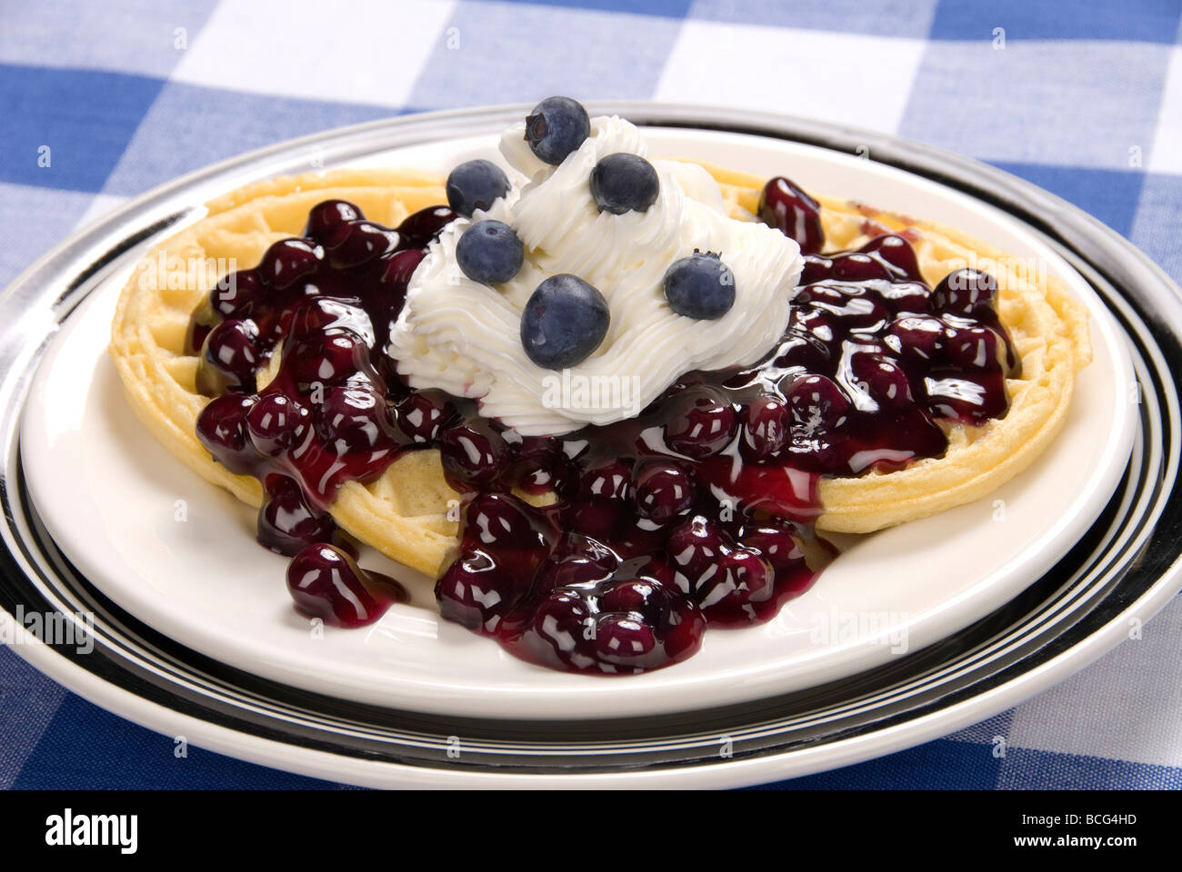 A very sweet breakfast of blueberry waffles with sweet whipped cream ...