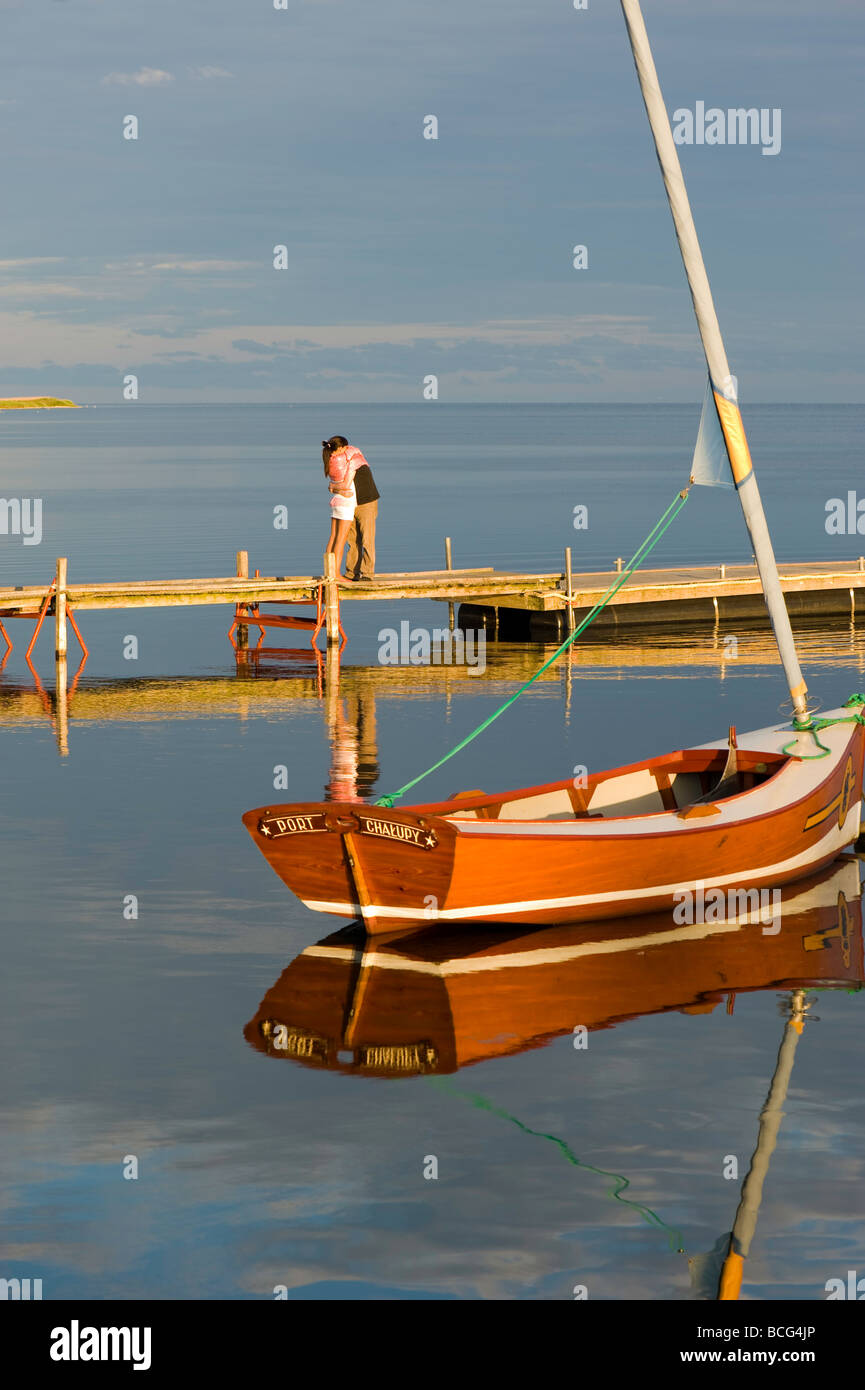 Young lovers on wooden pier Puck Bay early evening Hel Peninsula Baltic Sea Poland Stock Photo