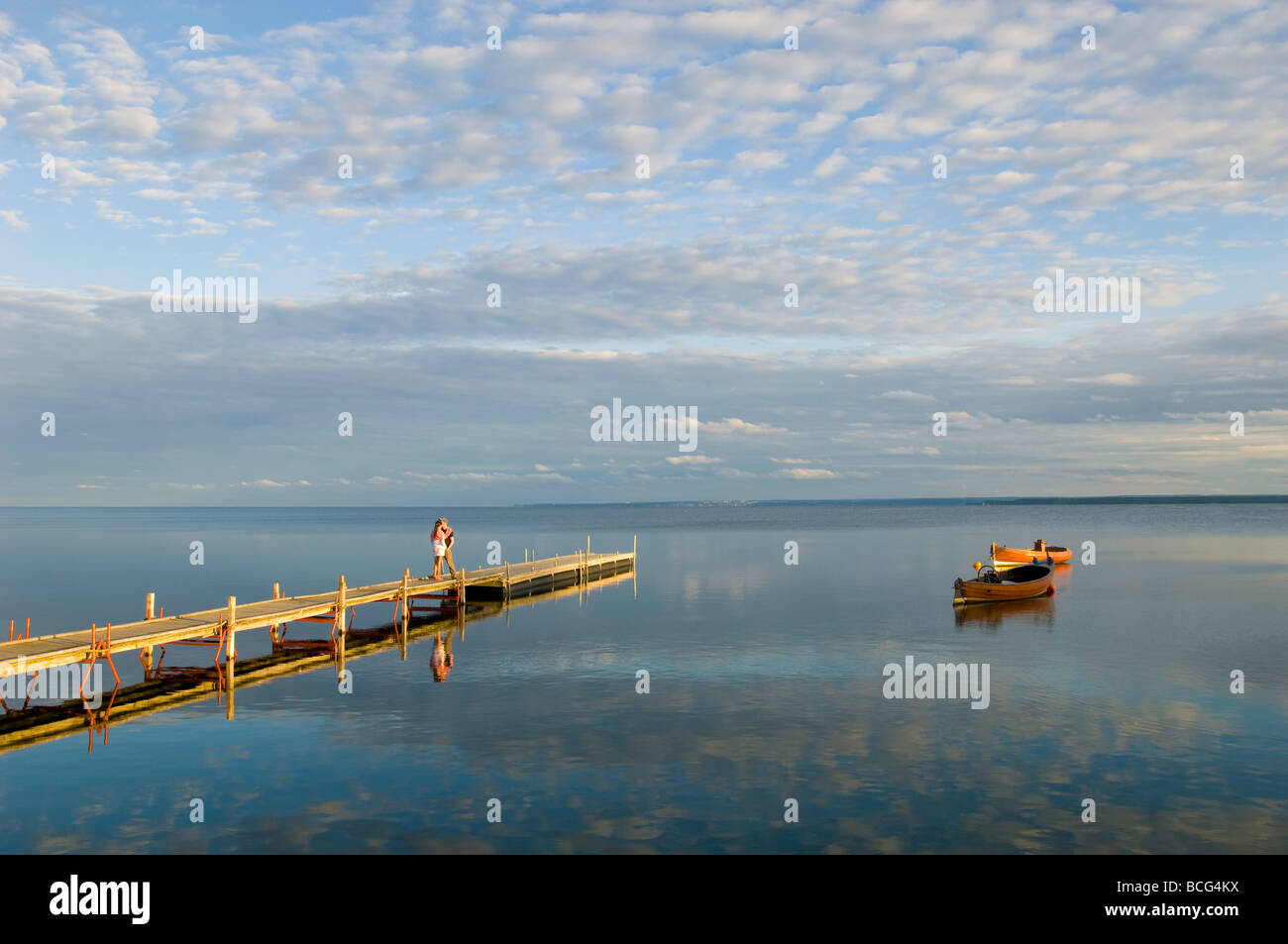 Young couple on wooden pier Hel Peninsula Baltic Sea Poland Stock Photo