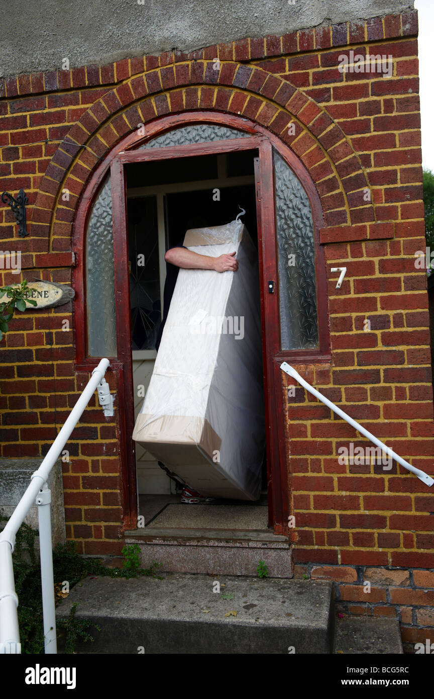 House and Furniture removals with removal men carrying loads Stock