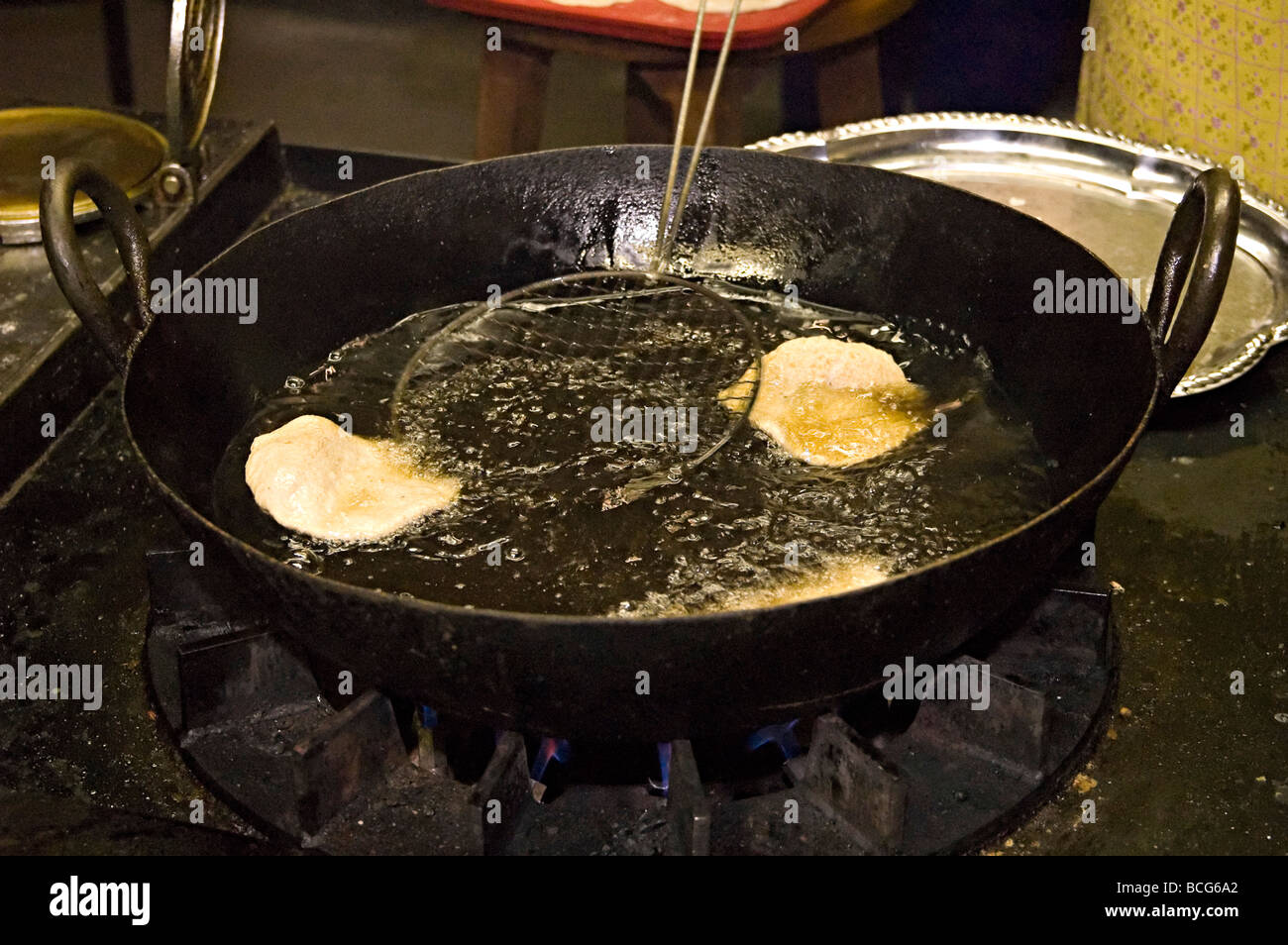 poppadoms being deep fat fried in a hindu temple in the uk in their