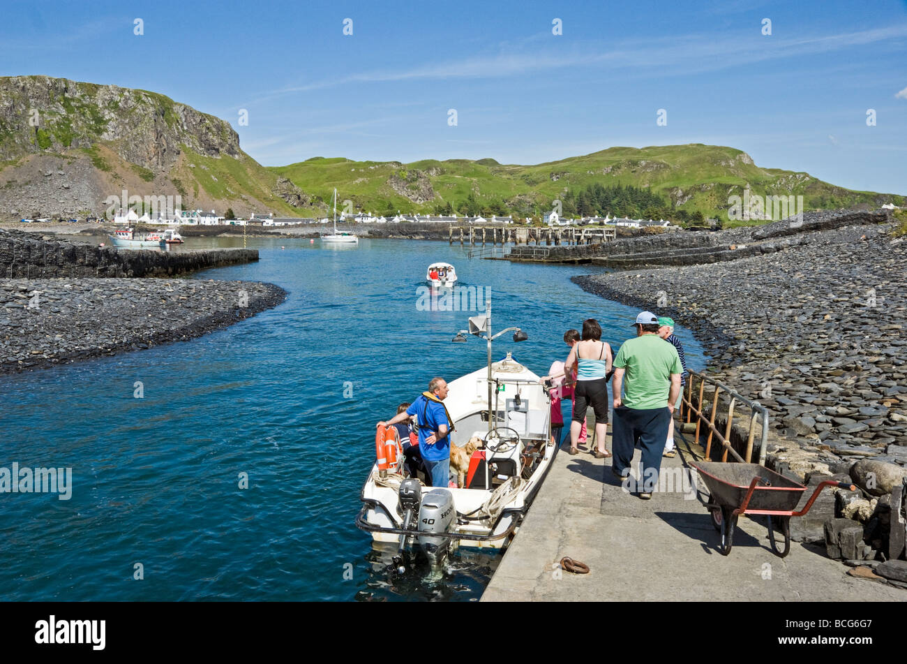 Passengers boarding the small ferry on the Island of Easdale taking passengers to the village of Easdale on the Island of Seil. Stock Photo