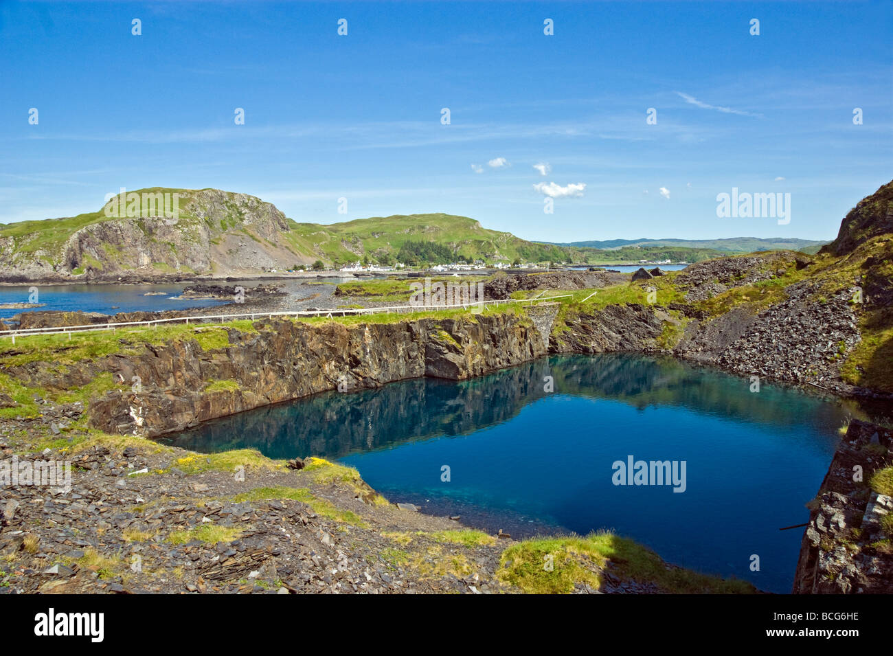 General view of Easdale on Seil in the Background from the disused slate quarries on the Island of Isdale in Scotland. Stock Photo