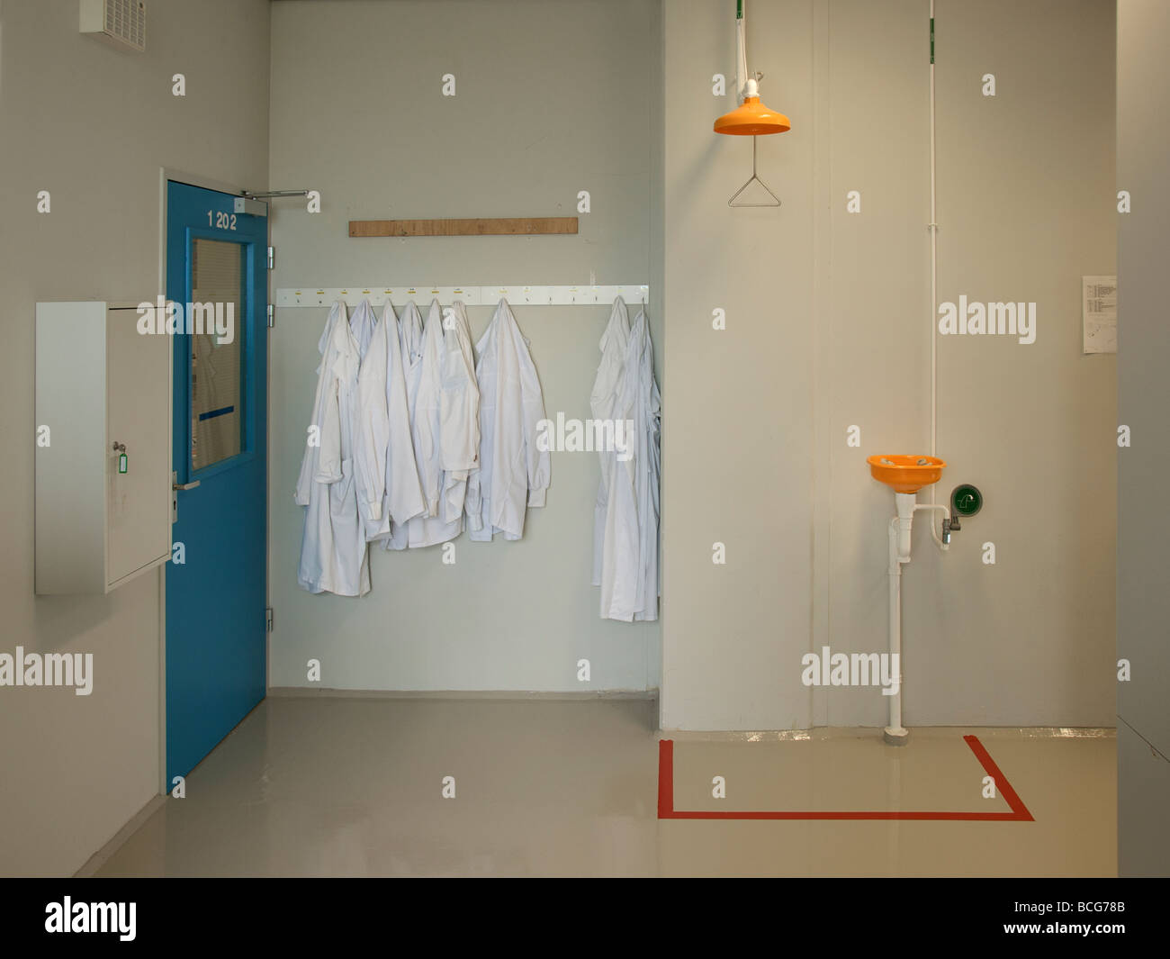 Lab entrance with white coats and first aid shower and eye douche Tilburg  the Netherlands Stock Photo - Alamy