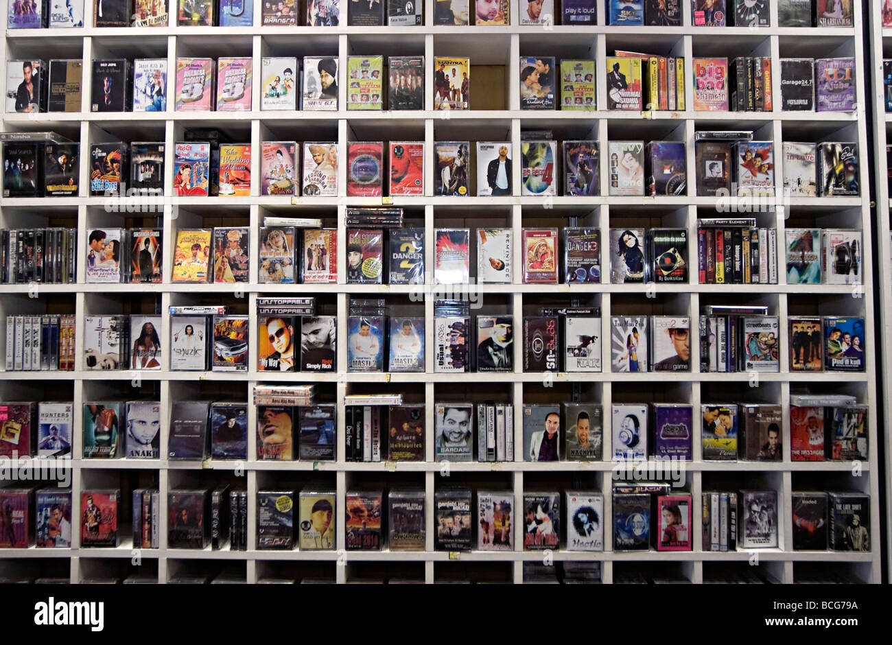 asian music tapes and cds on shelves in a shop. there is still a