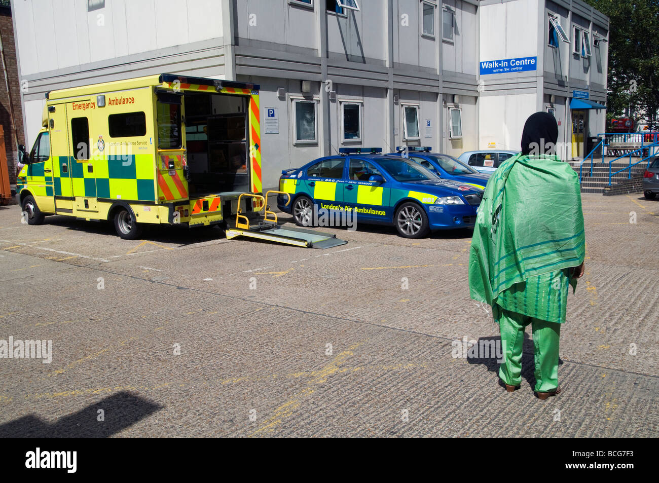 UK.Muslim woman waiting outside Royal London Hospital ambulance entrance.Photo by Julio Etchart Stock Photo