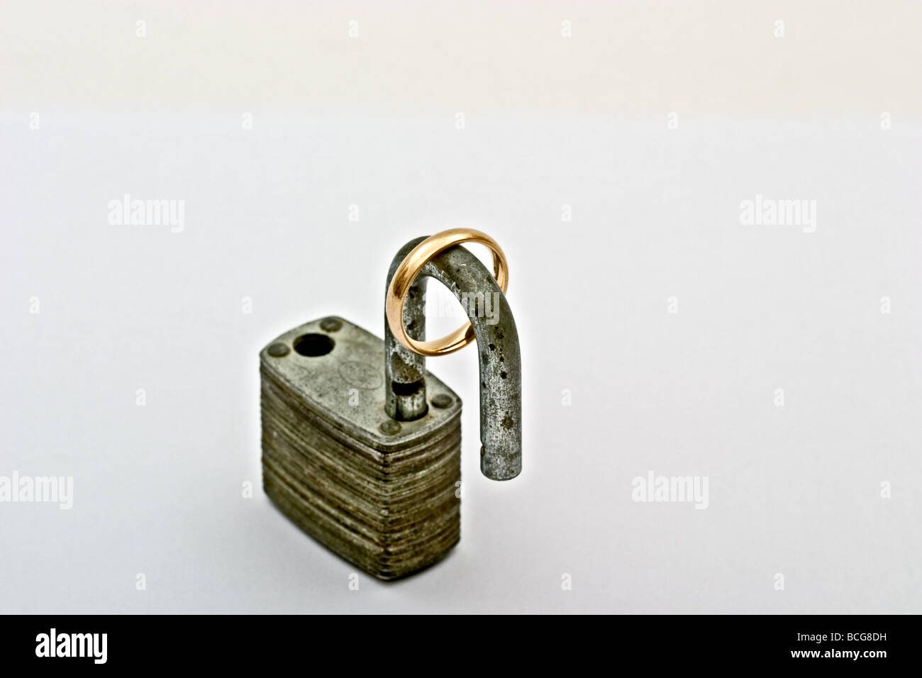 Open padlock with a gold wedding ring Stock Photo