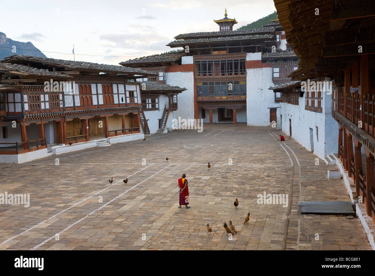 Monk in courtyard Trongsa Dzong monastery Trongsa Bhutan Stock Photo