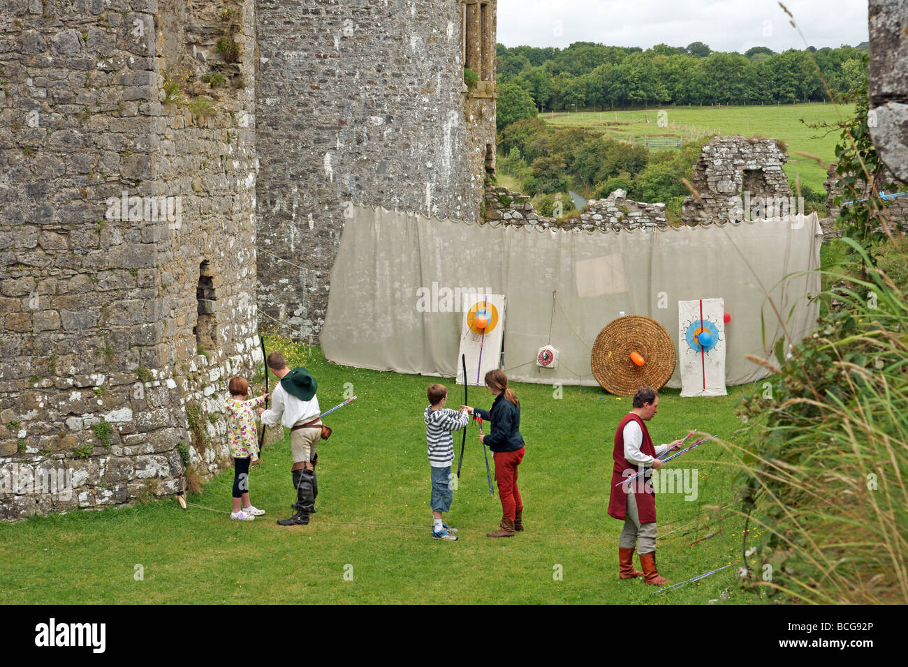 An archery lesson at Carew Castle in Pembrokeshire West Wales Stock
