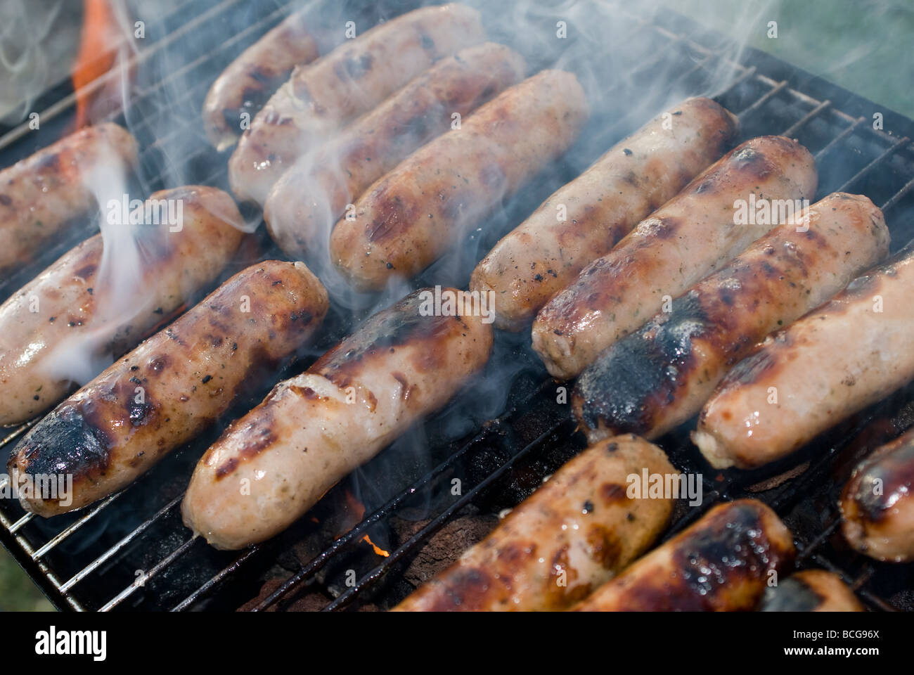 Sausages cooking on a barbecue grill Stock Photo Alamy