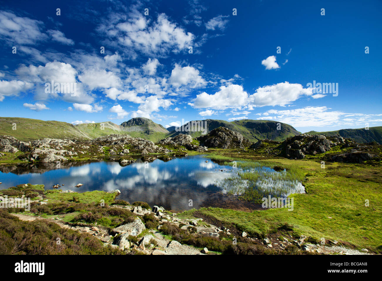 Innominate Tarn On Haystacks Mountain With 'Great Gable' And 'Kirk Fell' In The Distance 'The Lake District' Cumbria England UK Stock Photo