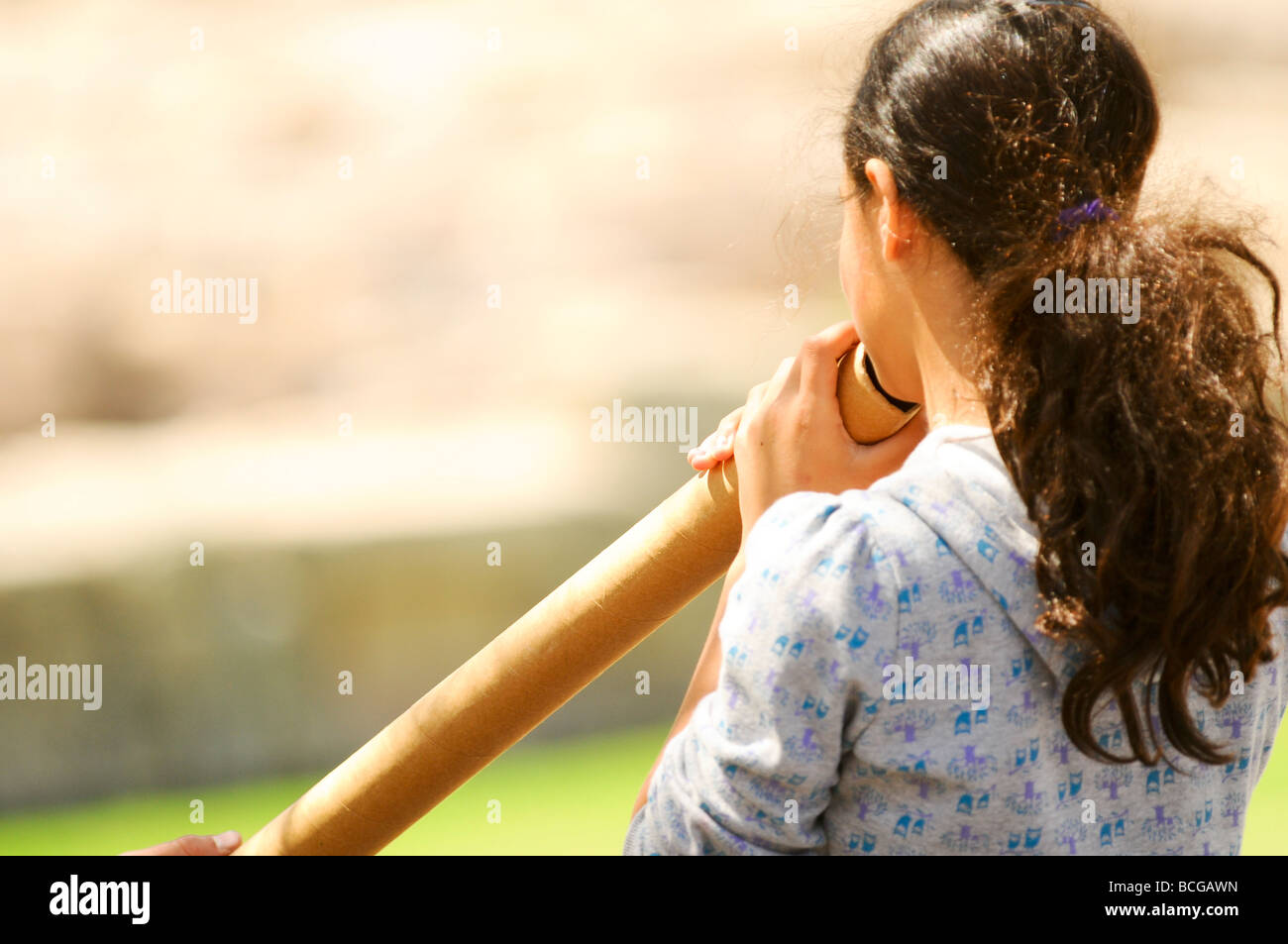 Israel Caesarea a girl blowing into a didjeridu an Aboriginal music instrument Stock Photo