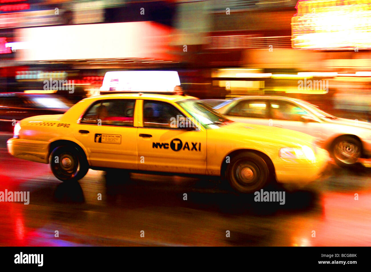 New York taxi driving through Times Square, New York inthe rain Stock Photo