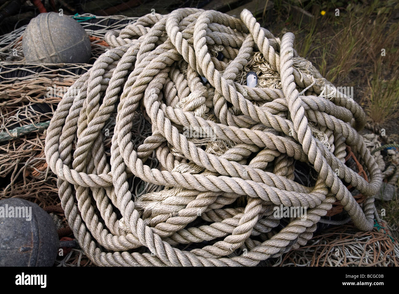 A pile of nylon rope or line used to tie ships to their mooring or dock ...
