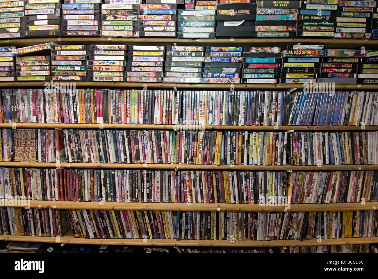 asian music tapes and cds on shelves in a shop. there is still a