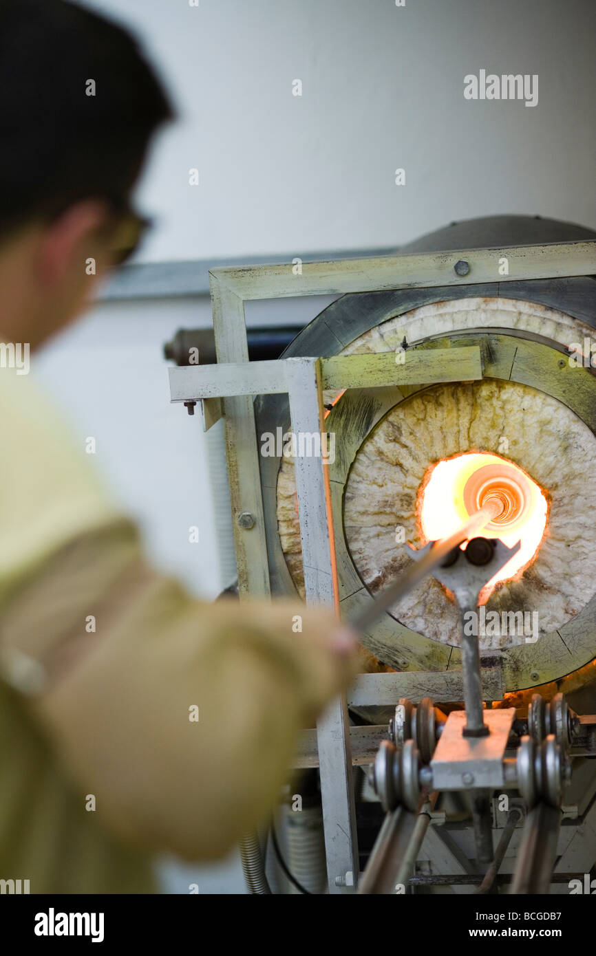 Colin Hawkins, glass blower at the Loco glass studio creating blown glass, Brewery Arts