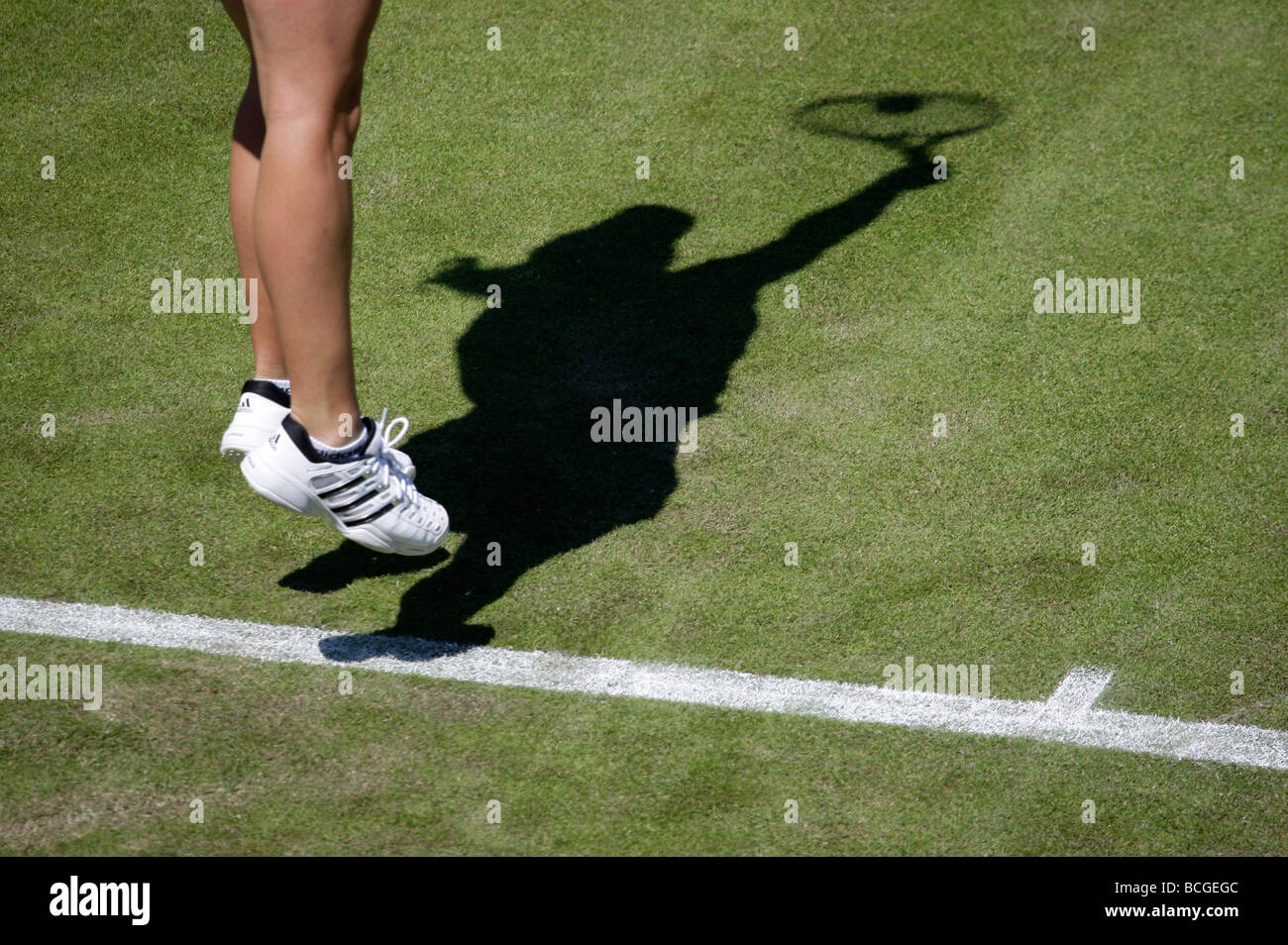 Shadow of a female player serving at the Wimbledon Championships Stock Photo