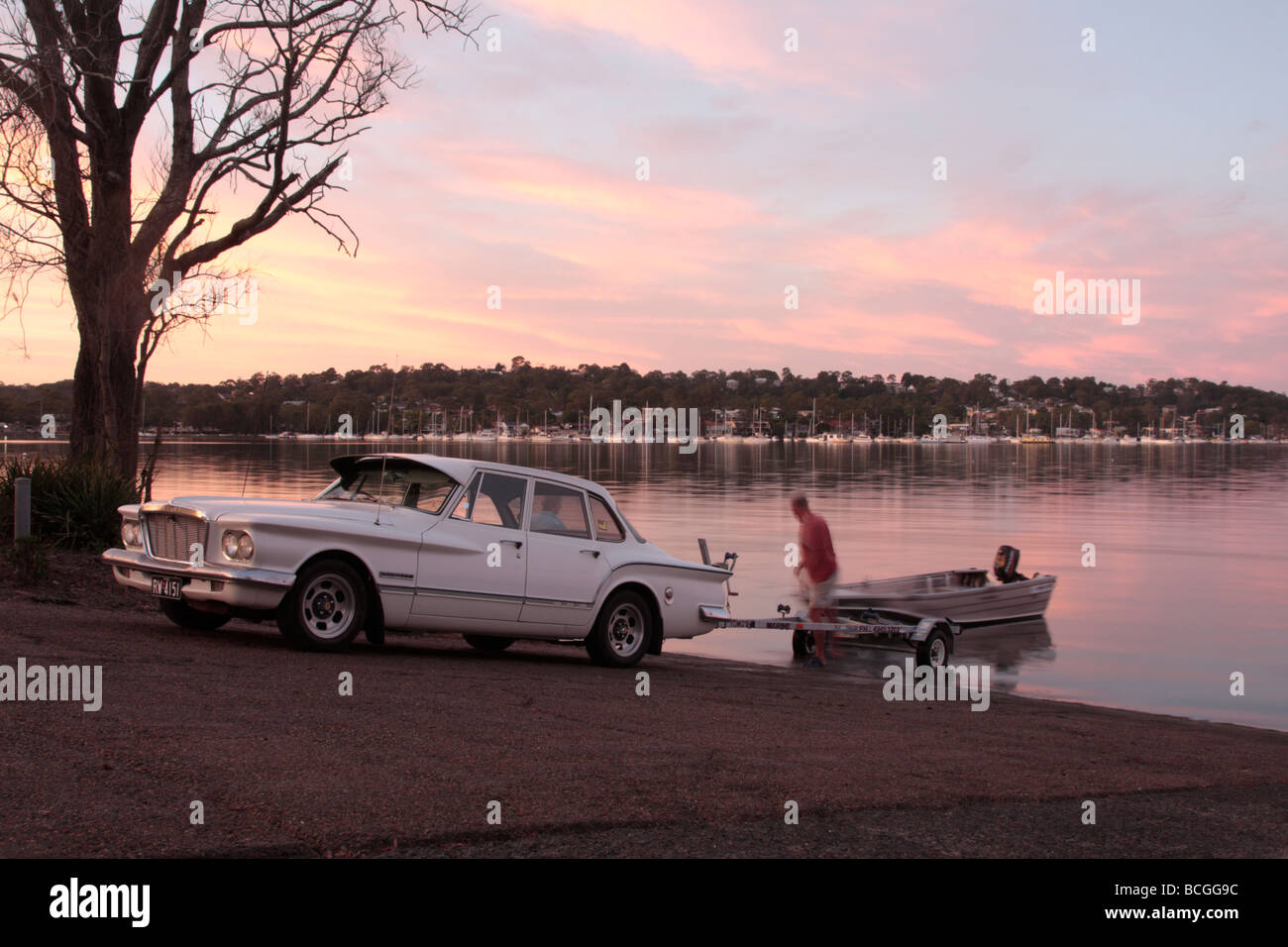 Launching a boat at dawn on lake Macquarie north of Sydney in New South wales Australia Stock Photo