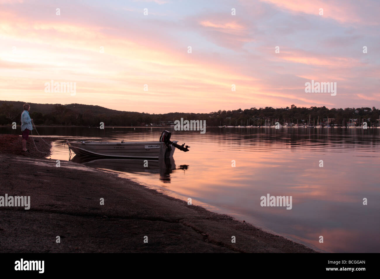 Launching a boat at dawn on lake Macquarie north of Sydney in New South wales Australia Stock Photo