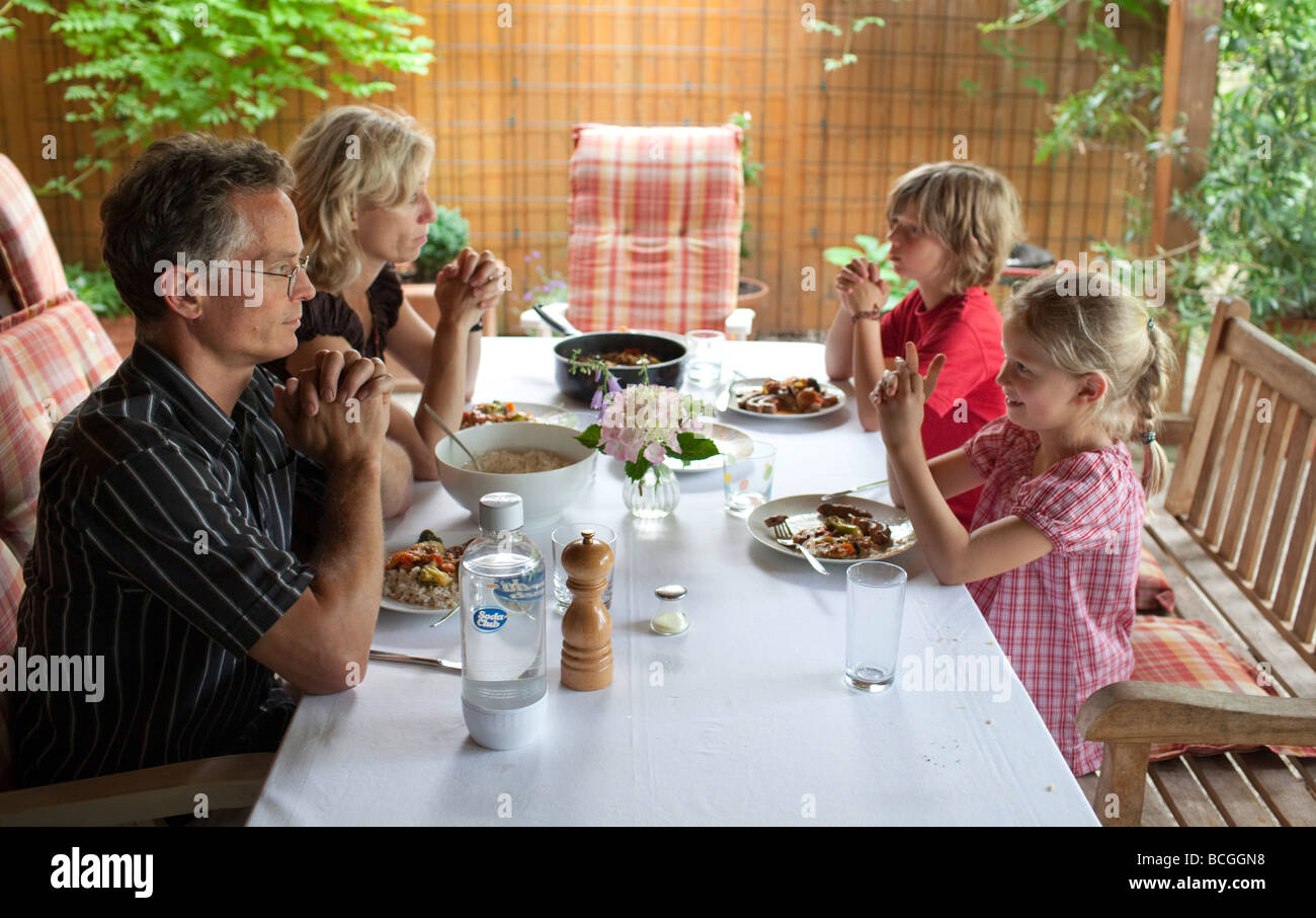 Family saying grace Stock Photo