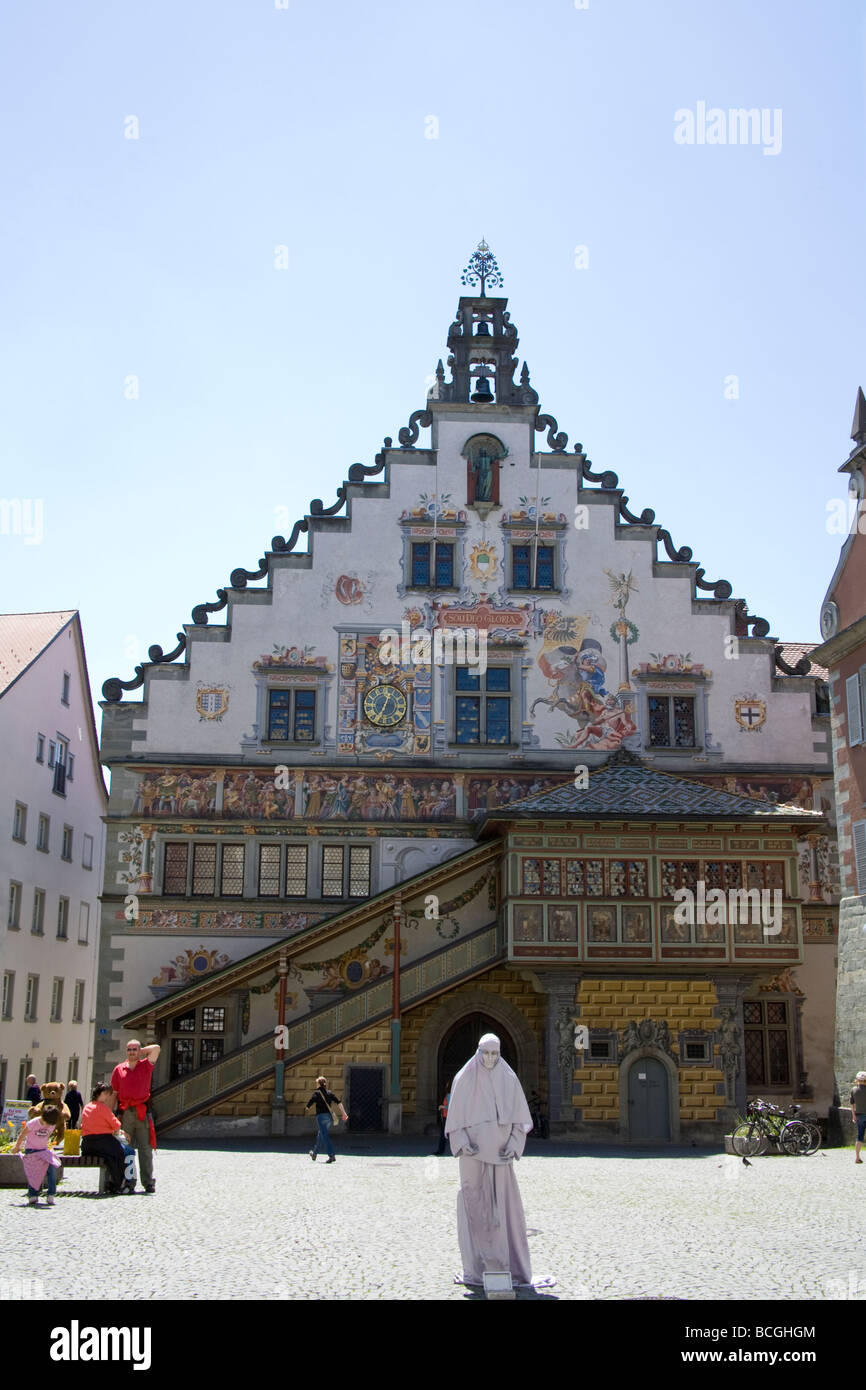 Lindau Bavaria Germany Mime artist in the square in front of the Old Town Hall covered in frescoes Stock Photo