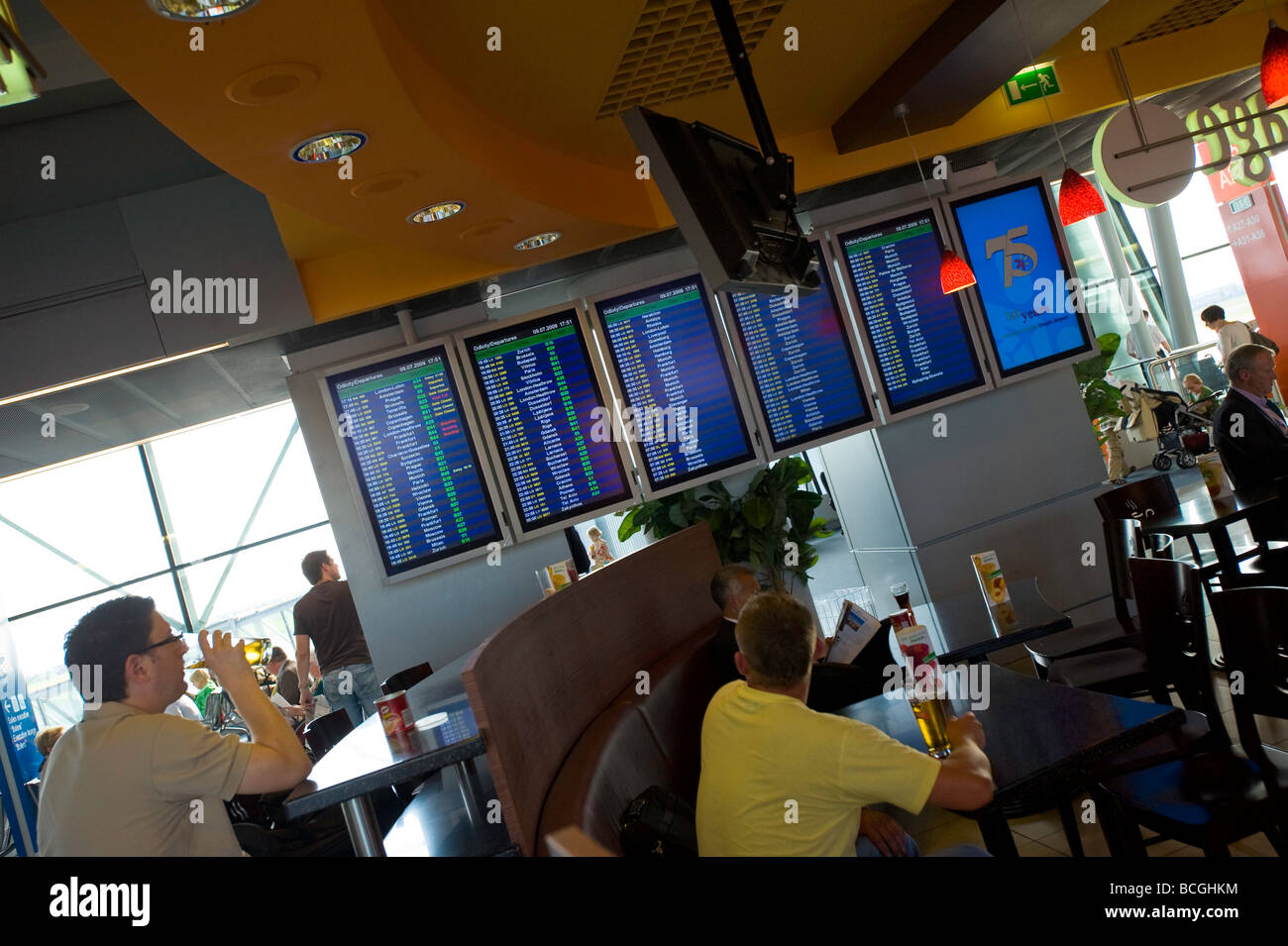 Passengers relax before departure at the cafe bar at Fryderyk Chopin Airport Warsaw Poland Stock Photo