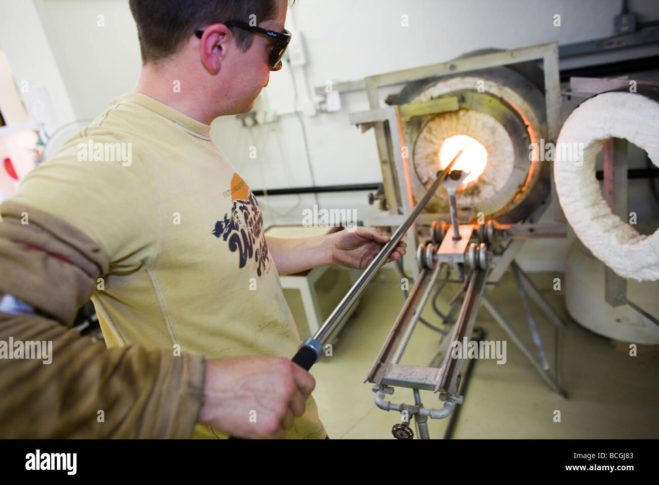 Colin Hawkins, glass blower at the Loco glass studio creating blown glass, Brewery Arts