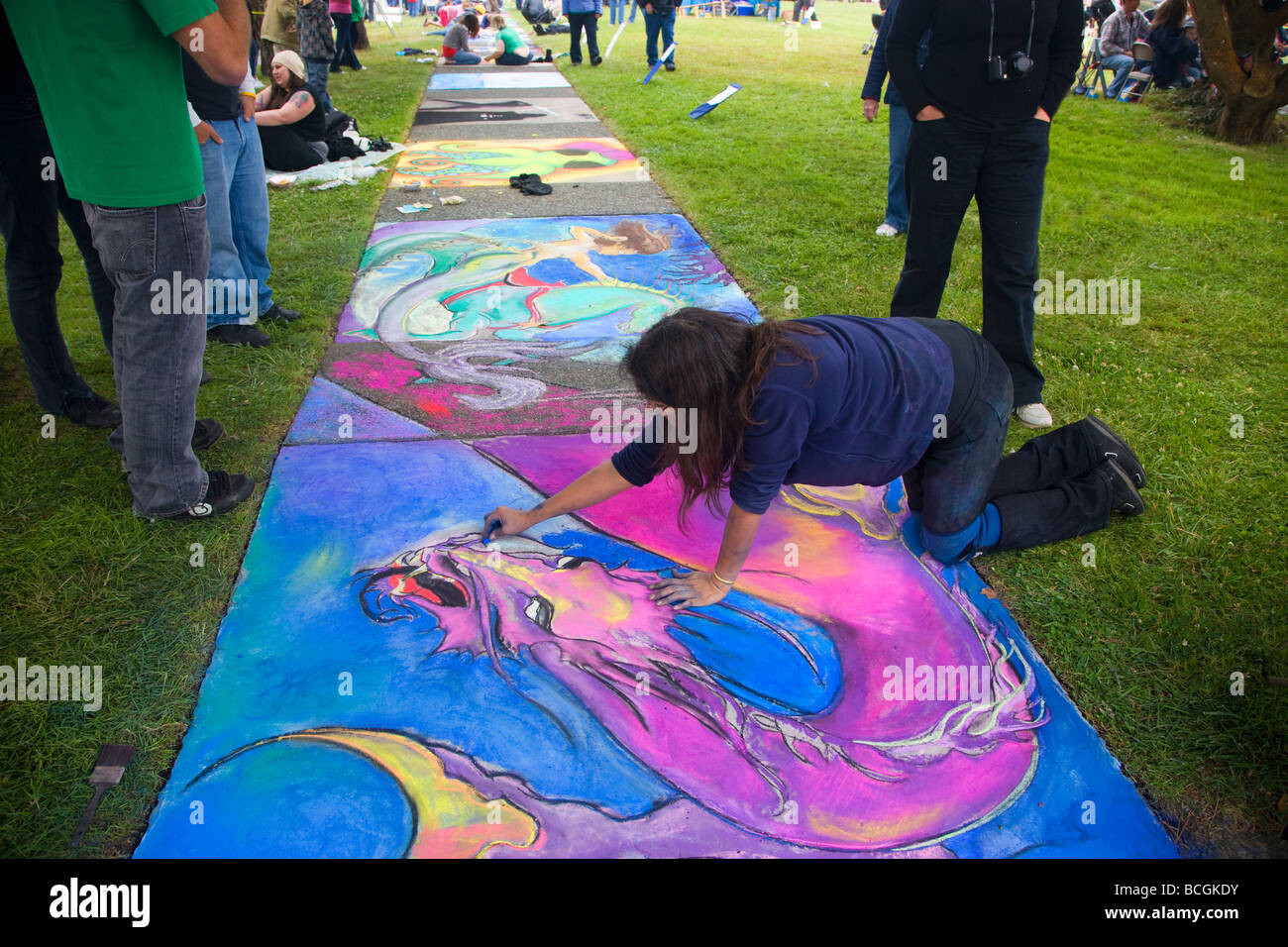 Young female artist working on pastel painting. Stock Photo