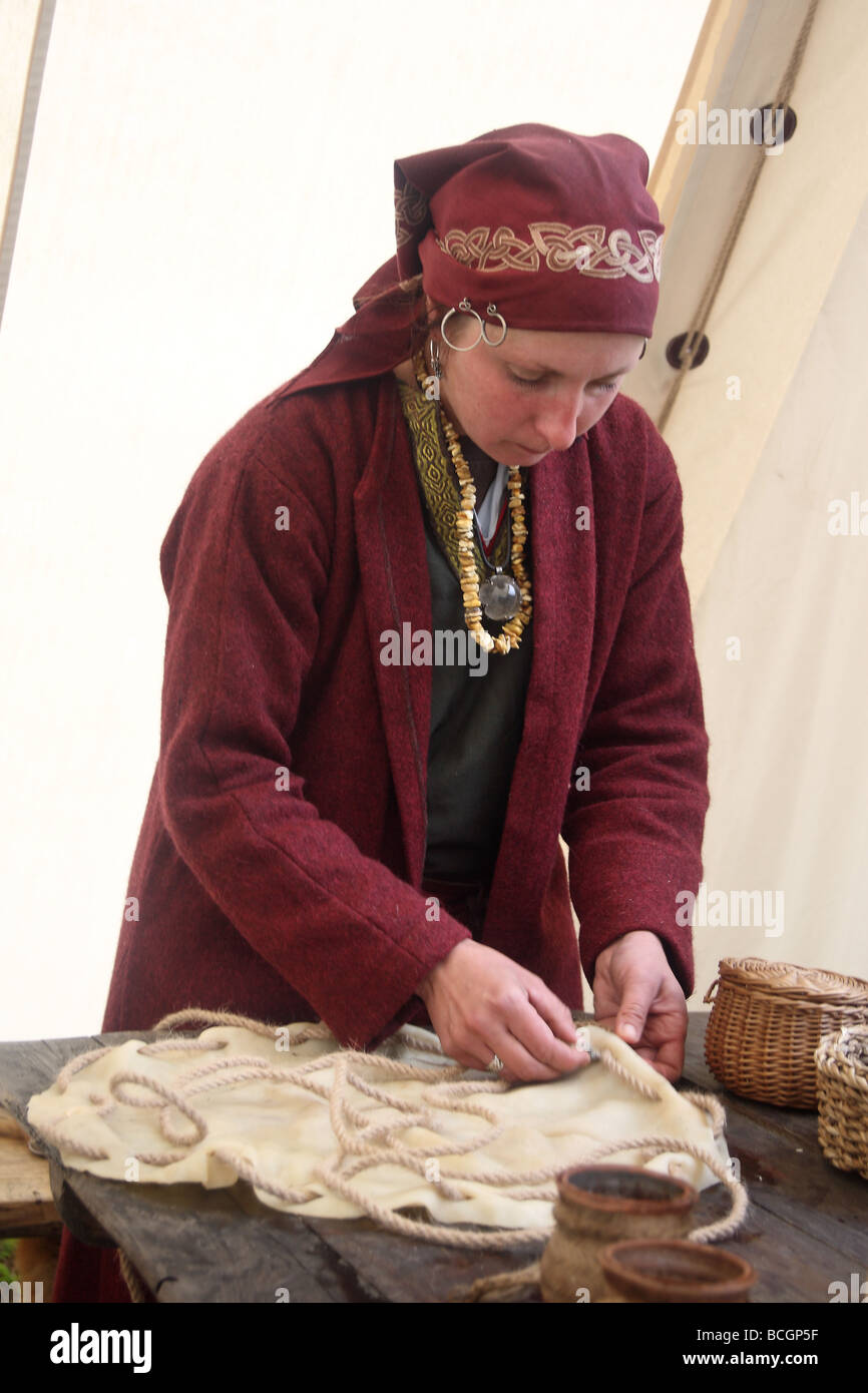 Presentation of an old, forgotten craftsman's professions. A woman in traditonal suit making a drum. Ogrodzieniec, Poland. Stock Photo