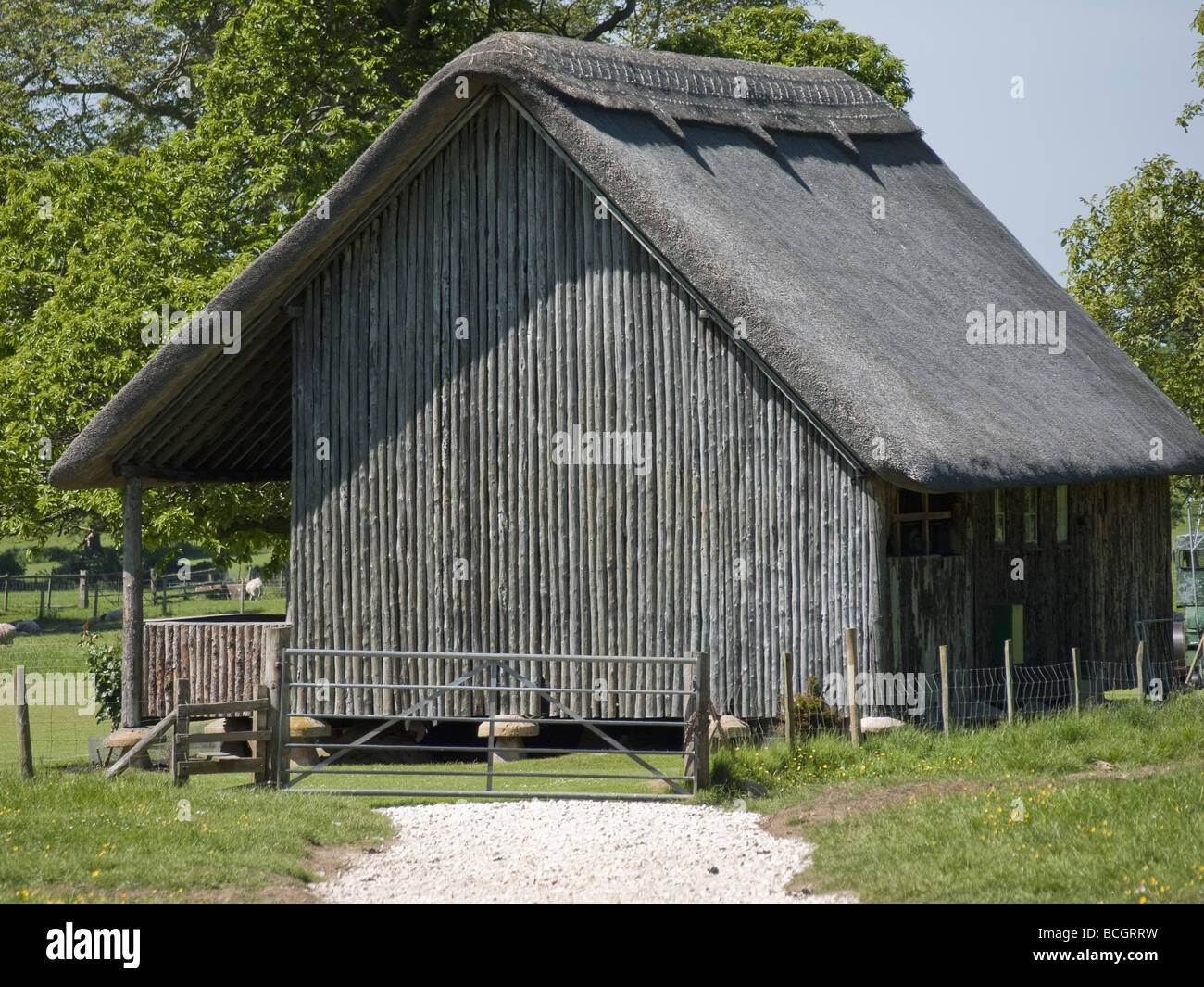 an old thatched barn on the cotswolds used as a cricket pavillion Stock Photo