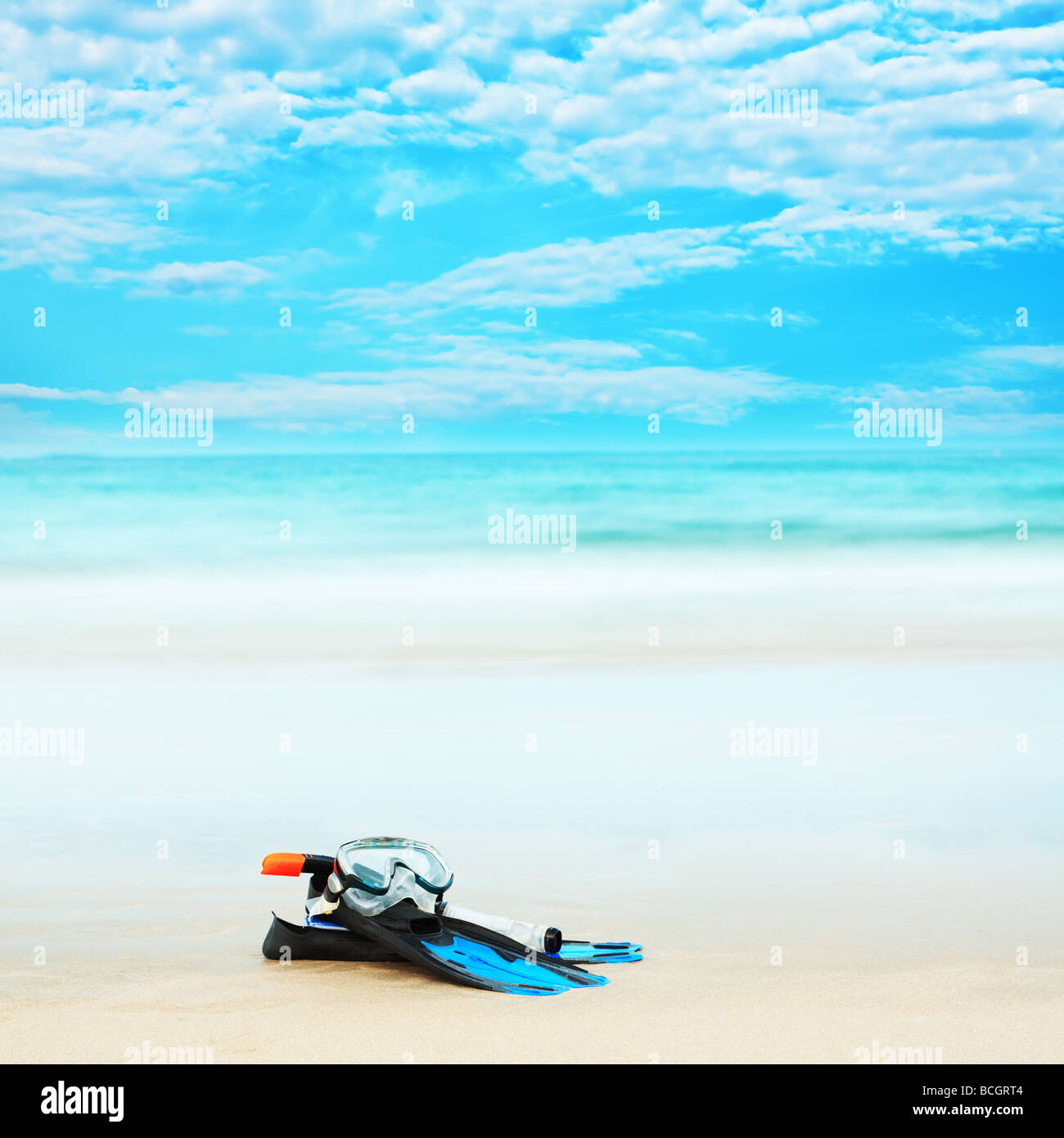 Snorkeling equipment mask and fins on white sand beach Stock Photo