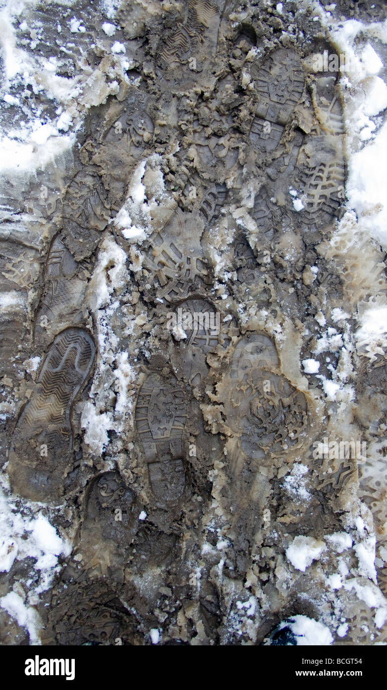 footsteps through muddy snow Stock Photo