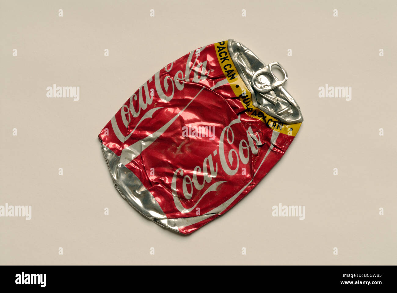 Flattened Coke can on white Stock Photo