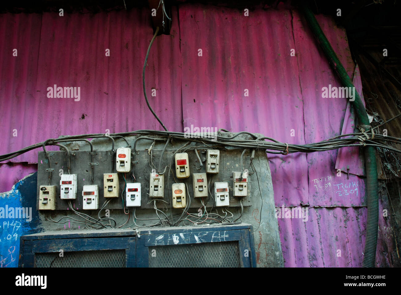 Electrical switches on a wall in the poor slum area of Dharavi in Mumbai (Bombay) in India. Stock Photo